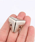 12 Piece Decorative Corner Protectors for Cabinets and Furniture Wood Corner Guards shown in hand for size reference