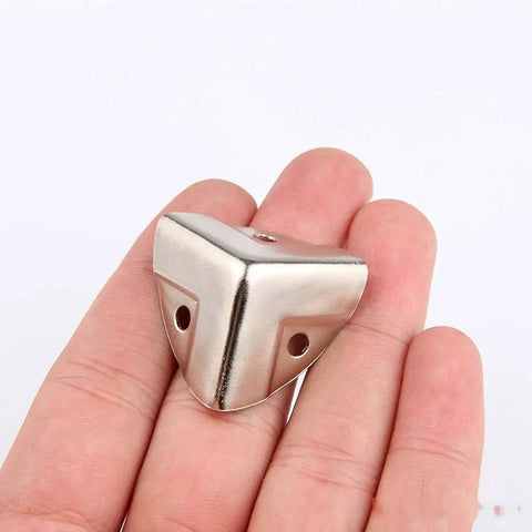 12 Piece Decorative Corner Protectors for Cabinets and Furniture Wood Corner Guards shown in hand for size reference
