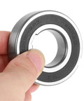Hand holding Beefed Up Heavy Duty Sprag Clutch One Way Bearing With Dual Keyway Freewheel 25x52x15mm CSK25PP with visible steel housing.