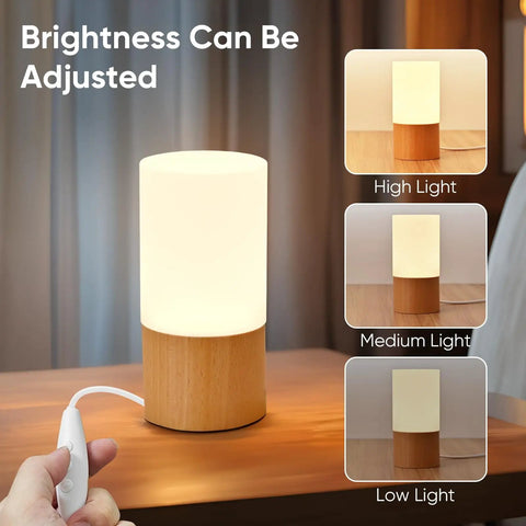 Cozy Beech Wood Table Lamp With Dimmable LED Light displaying adjustable brightness levels on a bedside table.