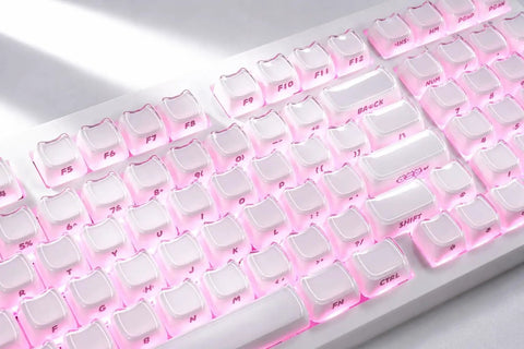 Wireless Mechanical Gaming Keyboard With 95 Percent Layout And Integrated Number Pad In Cream White Glossy Cat Ear Keycaps Running Smooth Creamy Switches With Vibrant Rgb Lighting For Your Sick Desk Setup close-up of pink backlit keys