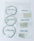 Silver wire and sheet varieties labeled soft, medium, and hard from All-In-One Jewelry Soldering Kit With Flux, 3rd Hand Base, Fiber Grip Tweezers, Silver Wire And Sheet, Ceramic Board And Soldering Pick - 12-Piece USA Made Set For DIY Jewelry Fans.