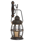 Rustic Metal Wall Sconce Lantern With Suspended Pillar Design Brown Glass Finish For Farmhouse Boho Eclectic Interiors Vibe