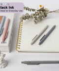 Go To Gel Pens Set Five Premium Retractable Gel Pens With Quick Dry Ink Fine Point Smooth Black Ink on a notebook