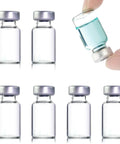 Six 2 ml clear glass sample vials with purple crimp-top caps; one held at angle shows blue liquid.