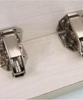 One To Ten Pack Cabinet Hinges 90 Degree Three Quarter Inch No Drilling Cupboard Door Hydraulic Hinges Soft Close Screws Included Durable Hardware Kit For Cabinets And Drawers with two hinges mounted on a wooden surface