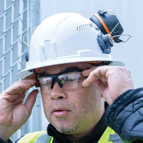 Worker wearing Ear Muffs With Full Brim Hard Hat Attachment For Construction And Manufacturing Pros On The Jobsite, 26 Decibels NRR Noise Reduction