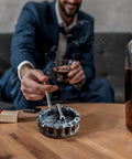 Man using Vintage Motorcycle Chain Ashtray With Wrench And Bike Motif For Biker Bars Harleys And Smoking Rooms A Dope Gift For Men Mechanics Smokers Great Desk Accessory For Man Caves And Home Bars on table