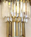 Sleek Led Wall Sconce Textured Crystal Glass Rod Shade Brushed Steel Frame close-up view showcasing shiny crystals and gold accents.