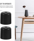 Dope Black Screw-In Furniture Legs 4 Pack for Sofas, Chairs and Dressers, black plastic feet next to a wooden table.