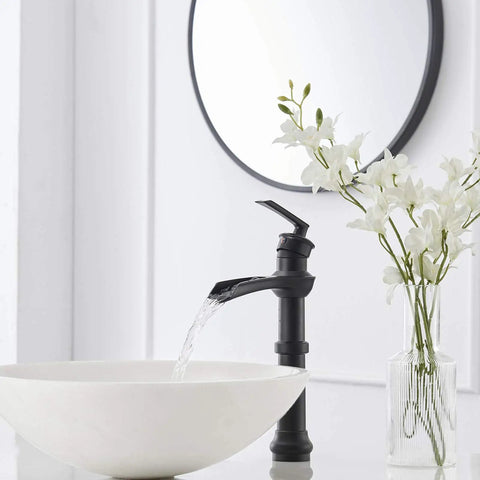 Dope Matte Black Vessel Sink Faucet With Waterfall Flow, Tall Single Hole Bathroom Vanity Mixer Tap next to white flowers