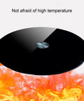 360 Degree Rotating Lazy Susan Turntable For Dining Tables And Kitchen Countertops Black Tempered Glass Base shown over flames
