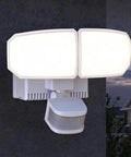 Patriot Lighting Dual-Head 240° Motion Sensing LED White Outdoor Security Flood Light w/Outlet Porch Light mounted on a wall.