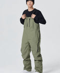 Man wearing army green waterproof ski bibs for outdoor sports, showcasing the Waterproof Ski Bibs Men Winter Snow Pants Overalls Snowboarding Outdoor Sports Breathable High Stretch All Day Warmth and Mobility Winter Gear Built to Handle Cold Days Durable Windproof.
