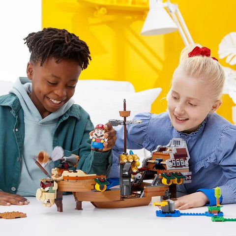 Children playing with Bowser's Airship Expansion Set For Super Mario Buildable Bowser Boss Ship That Unfolds To Reveal A Detailed Interior