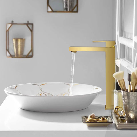 Gold Vessel Sink Faucet in Brushed Gold Finish installed beside a white vessel sink on a bathroom counter