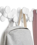 Slick Scandinavian Wall Mounted Coat Hooks Knockout Resin Organizer with gray backpack and scarf in hallway.