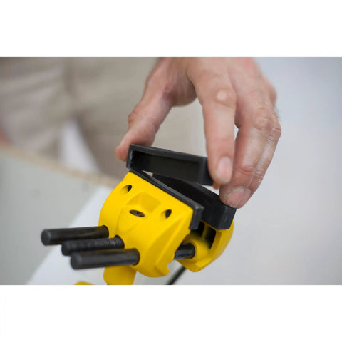 Person adjusting yellow and black MaxSteel Multi Angle Hobby Vice With 360-Degree Ball Joint, showing rubber jaw cover removal