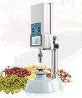 Top Notch Digital Grain Hardness Tester With Slick Mini Crop Firmness Gauge Featuring Bright Backlit Lcd Display And Nifty Kilo Newton Toggle For Quick Draw Farm Testing on a base with colorful grains in background.