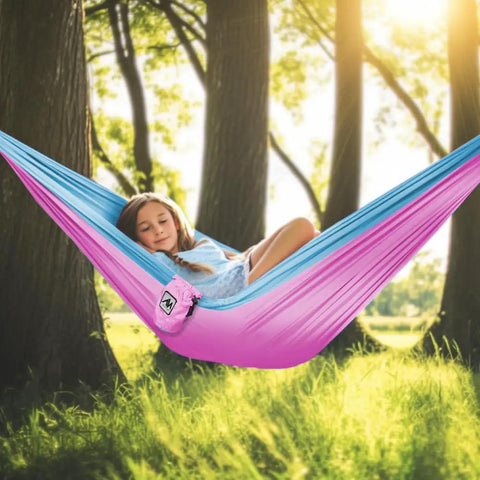 Girl relaxing in pink and blue Kids Camping Hammock For Outdoor Fun Ultralight Gear With Tree Straps And Carabiners