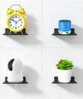 Straight Fire Black Metal Floating Wall Shelf For Echo Dot Alexa Smart Speakers Cameras Compact Rack mounted with clock, speaker, camera, plant.