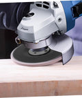 Close-up of angle grinder with 4 Inch Angle Grinder Sanding Disc Backing Plate Tray Pad For Secure Attachment And Smooth Wood Sanding