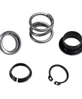KPALAG steering column upper bearing kit components: metal bearing rings, black plastic spacer, and retaining rings.