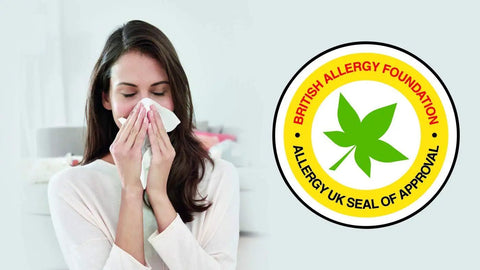 Woman using tissue next to Allergy UK seal of approval logo, associated with HEPA Active AirClean 30 Replacement Filter benefits.