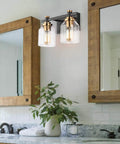 Slick Two Light Industrial Style Bathroom Vanity Light With Clear Glass Shades Matte Black Finish And Brushed Bronze Copper Accent Sockets