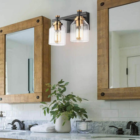 Slick Two Light Industrial Style Bathroom Vanity Light With Clear Glass Shades Matte Black Finish And Brushed Bronze Copper Accent Sockets