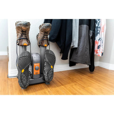 Heavy Duty Electric Shoe And Boot Dryer With Convection Heat Sweeps Moisture Out Of Work Boots And Ski Gear Four Port Quick Dry Cycle Kills Stink For Garage And Home Use with dirty boots attached.
