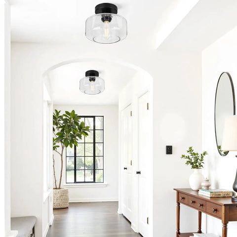 Industrial Semi Flush Mount Ceiling Light With Seeded Glass Shade installed in a modern white hallway with plants and a mirror.