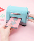Portable Die Cutting And Embossing Machine For Card Making And Scrapbooking No Fuss Mini Cutter in use with pink paper