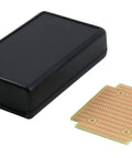 Black ABS Plastic Project Box With Battery Compartment And PR1593Q PCB next to proto PCB board, compact size shown.