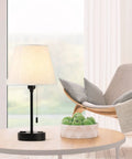 Set Of 2 Modern Nightstand Lamps With USB And AC Ports Great For Your Bedroom And Living Room Small Desk Lamps Ivory White Barrel Fabric Shade Silver Metal Base Linen Finish And Easy USB Charging For A Cozy Nighttime Vibe, lamp on table with chair and window view