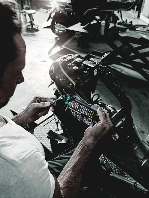 Man using Tool Check Plus Imperial 39 Piece Bit And Socket Set With Color Coding for Quick Identification in a garage setting