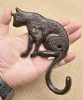 Heavy Duty Cast Iron Cat Wall Hooks Two Pack Featuring A Totally Badass Antique Dark Rust Finish Perfect For Holding Coats Keys And Furry Pet Leashes While Adding Killer Vintage Country Vibes To Your Space - single hook in hand