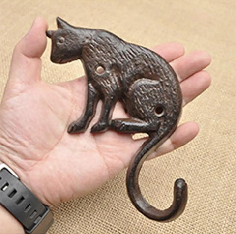 Heavy Duty Cast Iron Cat Wall Hooks Two Pack Featuring A Totally Badass Antique Dark Rust Finish Perfect For Holding Coats Keys And Furry Pet Leashes While Adding Killer Vintage Country Vibes To Your Space - single hook in hand