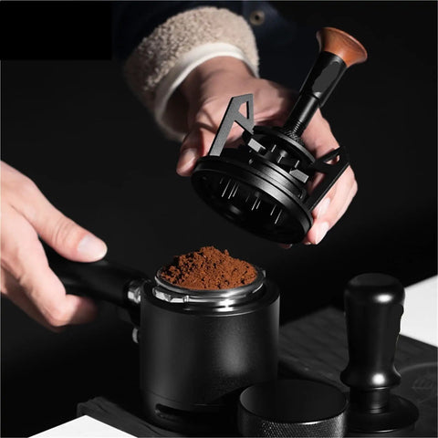 Rotary Espresso WDT Tool Set With Precision Dosing Funnel And Upright Stand To Kick Hard Pack To The Curb And Nail Your Pull Shots For Home Brew Junkies Seeking Ridiculously Smooth Distribution Daily, showing hands using the tool above coffee grounds.