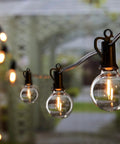 Outdoor String Lights 50 Foot Long With 25 Plus 2 G40 LED Bulbs, close-up of globe bulb on patio in evening light