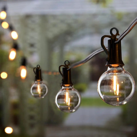 Outdoor String Lights 50 Foot Long With 25 Plus 2 G40 LED Bulbs, close-up of globe bulb on patio in evening light