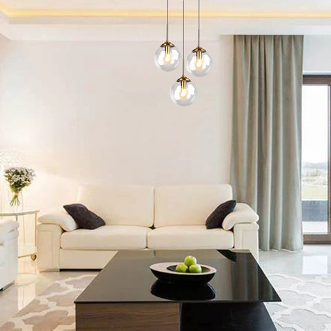 Three Light Pendant Light Fixtures With Brass Lamp Holder And Handblown Glass Shade in bright living room setting