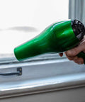 Person using hairdryer on Indoor Three Window Shrink Film Insulator Kit With Crystal Clear Film 62 By 126 Inches Includes 54 Feet Double Sided Tape