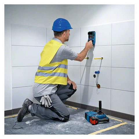 Worker using Hardcore Stud Finder Wall Scanner Boasting Dead On Rebar And Wire Detection on tiled wall.
