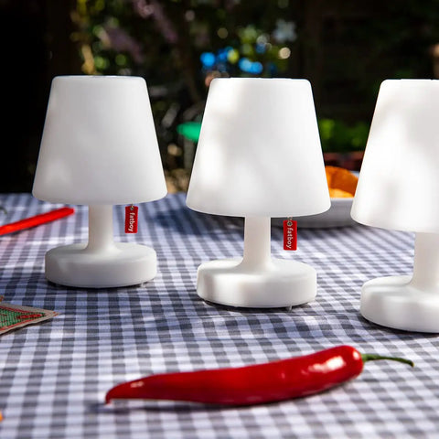 Edison The Mini Set of 3 Grab-and-Go Portable LED Lamps, Cordless and Rechargeable on checkered table outdoors.