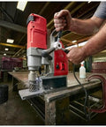 One Five Eight Inch Compact Electromagnetic Drill With 13 Amp High Torque Motor And Two Speed Transmission cutting through steel.