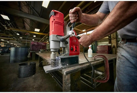 One Five Eight Inch Compact Electromagnetic Drill With 13 Amp High Torque Motor And Two Speed Transmission cutting through steel.