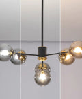 Six Light Glass Globe Sputnik Chandelier In Matte Black With Amber Shade, showcasing its modern design in a home interior setting.