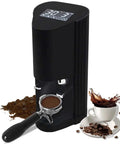 Game Changing 58Mm Automatic Espresso Tamper Machine With Touch Screen Dial And Adjustable Pressure For Hassle Free Coffee Puck Compaction In Tough Stainless Steel placed beside a cup of coffee.