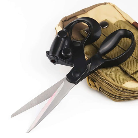 Front view of professional laser-guided fabric scissors with ergonomic black handle and magnetic storage